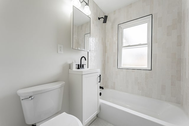 full bathroom featuring toilet, vanity, and washtub / shower combination