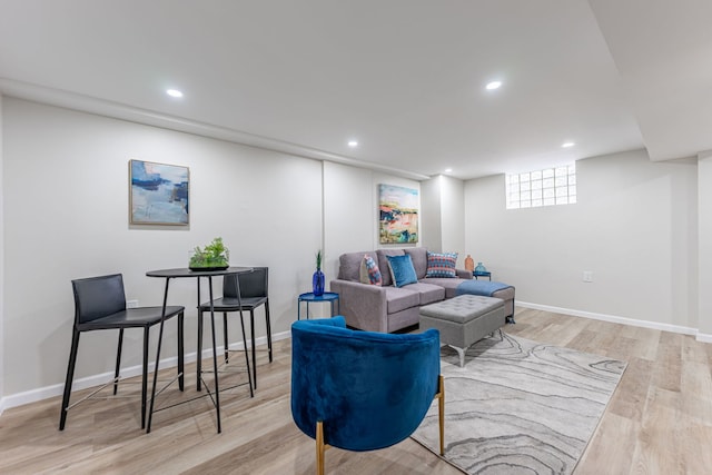 living room with baseboards, light wood-type flooring, and recessed lighting