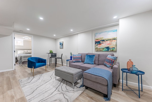 living room featuring recessed lighting, baseboards, and wood finished floors