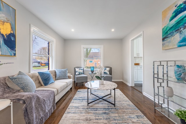living room featuring dark wood-style flooring, baseboards, and recessed lighting