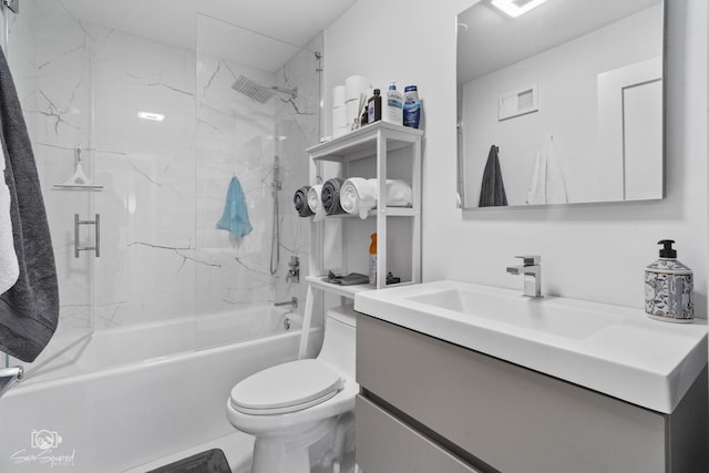 bathroom featuring toilet, vanity, and tub / shower combination