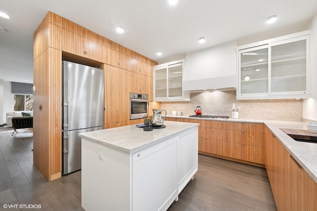 1333 N Bell Ave, Chicago, IL 60622 - kitchen featuring appliances with stainless steel finishes, wood-type flooring, a center island, backsplash, and modern cabinets
