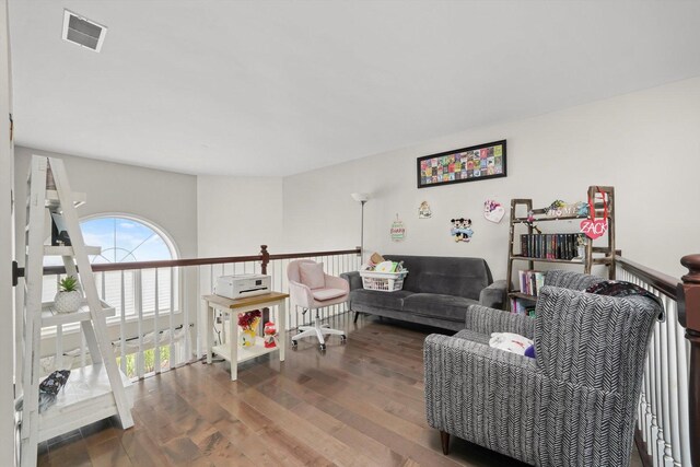 living room featuring visible vents and wood finished floors