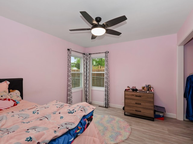 11554 S Neenah Ave, Worth, IL 60482 - bedroom with baseboards, light wood finished floors, and ceiling fan