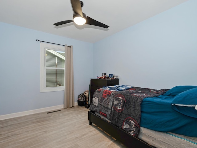 11554 S Neenah Ave, Worth, IL 60482 - bedroom with light wood-style flooring, baseboards, and a ceiling fan