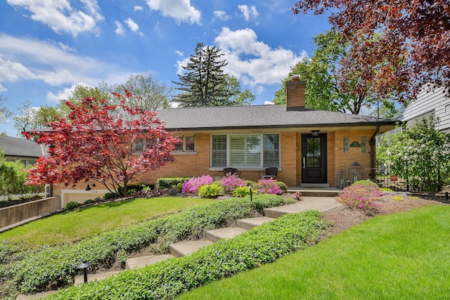 254 Spring Ave, Glen Ellyn, IL 60137 - view of front facade featuring a chimney, a front lawn, covered porch, brick siding, and roof with shingles