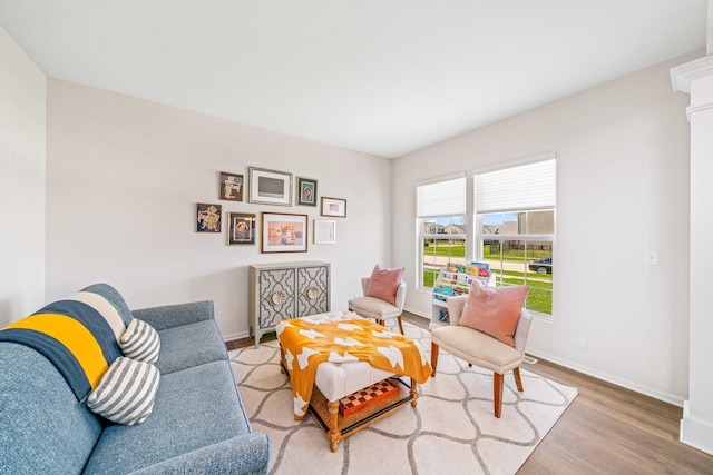 living area with wood finished floors and baseboards