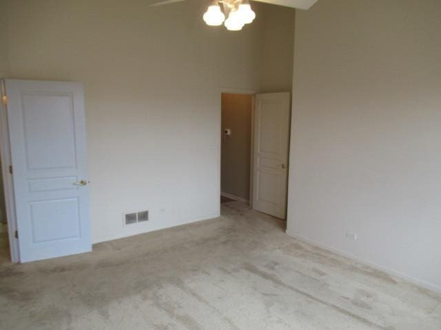 2844 Waterfront Ave, Algonquin, IL 60102 - carpeted empty room with visible vents, a ceiling fan, and a high ceiling