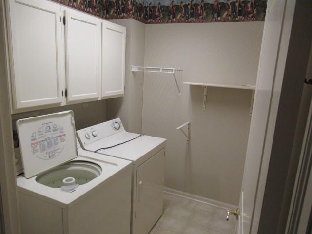 2844 Waterfront Ave, Algonquin, IL 60102 - clothes washing area with cabinet space, baseboards, and washing machine and dryer
