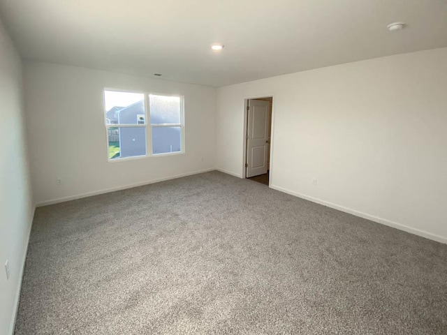 2011 Winterberry Trl, Wonder Lake, IL 60097 - spare room featuring baseboards and dark carpet