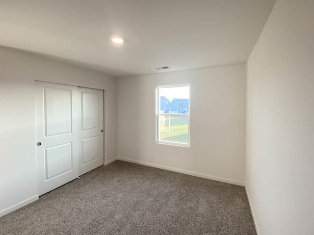 2011 Winterberry Trl, Wonder Lake, IL 60097 - unfurnished bedroom featuring a closet, visible vents, baseboards, and carpet floors