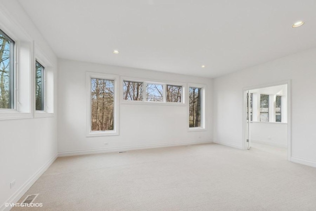 spare room with light carpet, baseboards, visible vents, and recessed lighting