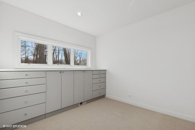 unfurnished bedroom featuring light colored carpet, baseboards, and recessed lighting
