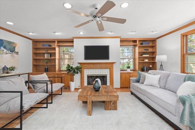 1945 Bosworth Ln, Northfield, IL 60093 - living area featuring crown molding, built in features, healthy amount of natural light, ceiling fan, and a fireplace