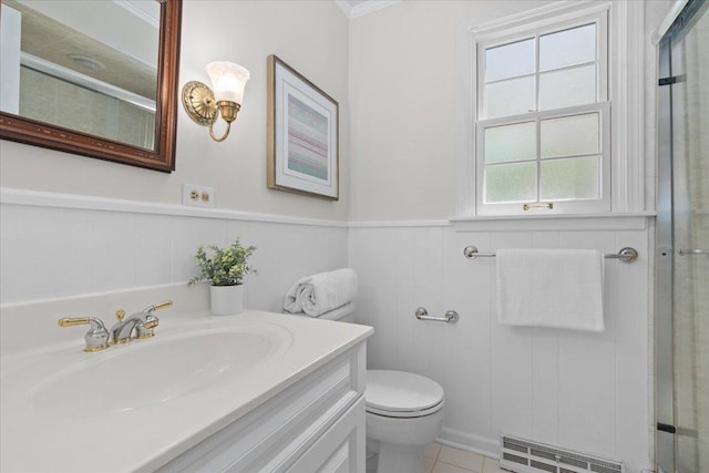 1945 Bosworth Ln, Northfield, IL 60093 - bathroom with toilet, vanity, a shower with shower door, a wainscoted wall, and tile patterned floors