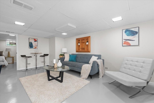 1945 Bosworth Ln, Northfield, IL 60093 - living area featuring finished concrete flooring, a drop ceiling, and baseboards