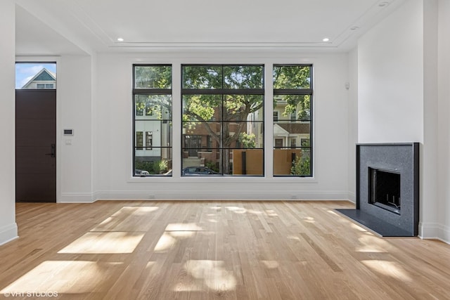 3846 N Bell Ave, Chicago, IL 60618 - unfurnished living room featuring light wood finished floors, healthy amount of natural light, a premium fireplace, and recessed lighting