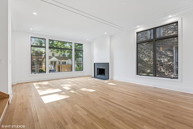 3846 N Bell Ave, Chicago, IL 60618 - unfurnished living room with a fireplace with flush hearth, light wood-style flooring, and recessed lighting