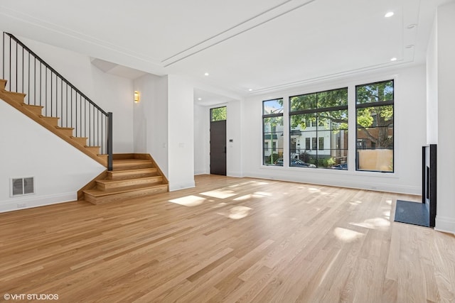 3846 N Bell Ave, Chicago, IL 60618 - unfurnished living room featuring light wood-type flooring, stairway, and recessed lighting