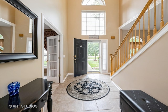 1641 Foster Cir, Algonquin, IL 60102 - foyer entrance featuring a high ceiling, tile patterned flooring, stairway, and baseboards