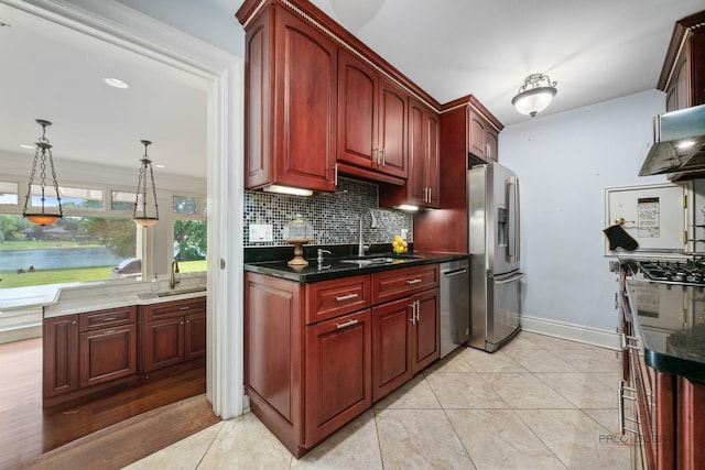 2426 Lexington Dr, Long Grove, IL 60047 - kitchen with stainless steel appliances, dark brown cabinets, tasteful backsplash, decorative light fixtures, and light tile patterned floors