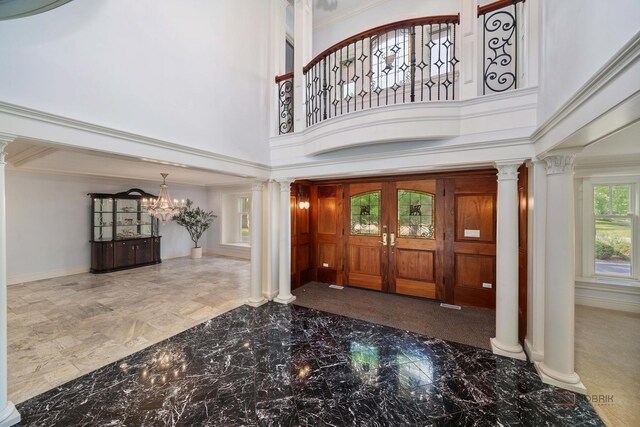 2426 Lexington Dr, Long Grove, IL 60047 - entrance foyer featuring marble tiled flooring, decorative columns, a towering ceiling, a chandelier, and ornamental molding