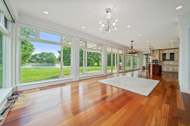 2426 Lexington Dr, Long Grove, IL 60047 - unfurnished living room featuring a chandelier, a water view, ornamental molding, dark wood-type flooring, and recessed lighting