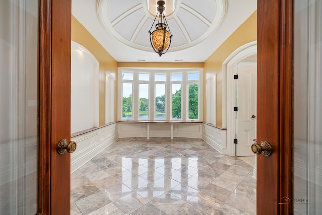 2426 Lexington Dr, Long Grove, IL 60047 - foyer entrance with a decorative wall, arched walkways, a wainscoted wall, and light marble finish flooring