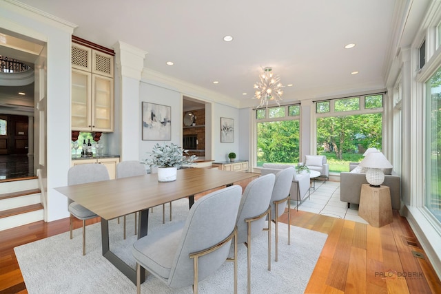 2426 Lexington Dr, Long Grove, IL 60047 - dining area featuring a chandelier, ornamental molding, plenty of natural light, light wood-style floors, and recessed lighting