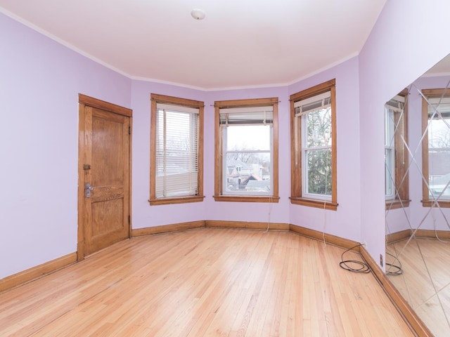 4249 W Melrose St, Chicago, IL 60641 - unfurnished room with light wood-style floors, baseboards, and crown molding