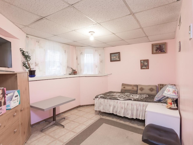 4249 W Melrose St, Chicago, IL 60641 - bedroom featuring tile patterned floors, a paneled ceiling, and baseboards