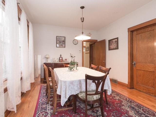 4249 W Melrose St, Chicago, IL 60641 - dining room with visible vents, baseboards, and light wood-style flooring