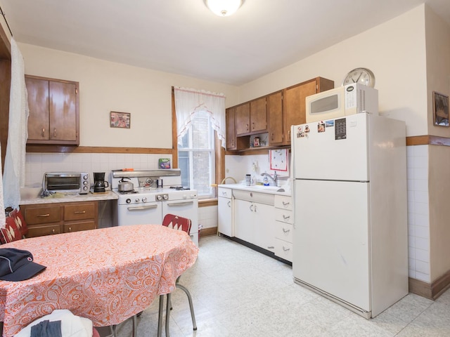 4249 W Melrose St, Chicago, IL 60641 - kitchen featuring a toaster, white appliances, light countertops, and light floors