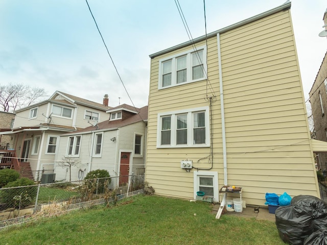 4249 W Melrose St, Chicago, IL 60641 - rear view of property with central AC, fence, and a lawn