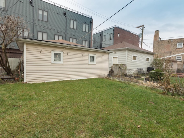 4249 W Melrose St, Chicago, IL 60641 - back of house featuring fence and a lawn