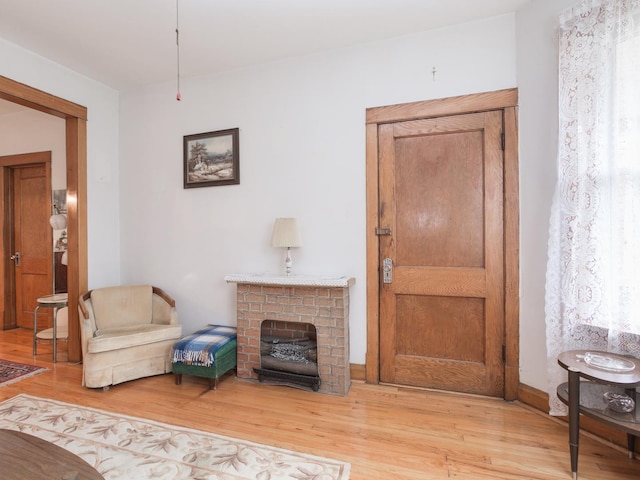 4249 W Melrose St, Chicago, IL 60641 - living area featuring a brick fireplace and light wood-type flooring