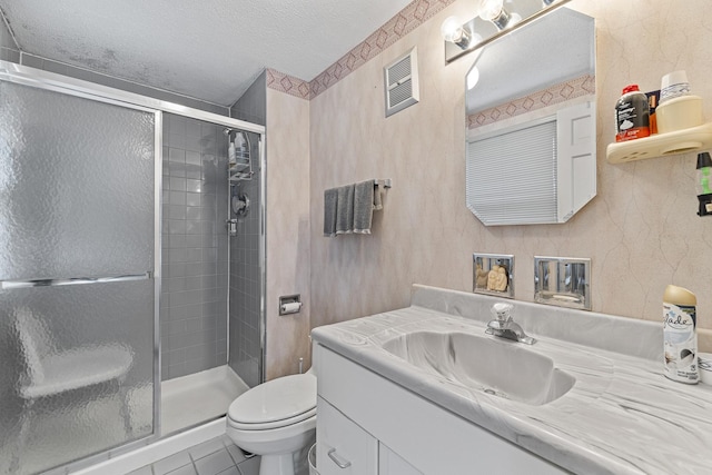 bathroom featuring a textured ceiling, toilet, visible vents, a shower stall, and vanity