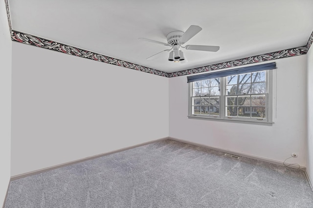 empty room featuring ceiling fan, baseboards, carpet flooring, and visible vents