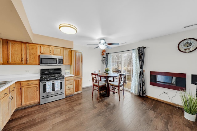 26247 N Green St Unit 2F, Mundelein, IL 60060 - kitchen featuring dark wood finished floors, light countertops, visible vents, appliances with stainless steel finishes, and ceiling fan