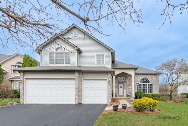 851 Bluestem Dr, Bolingbrook, IL 60440 - view of front of home with roof with shingles, an attached garage, a front lawn, and aphalt driveway