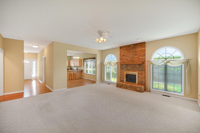 9154 Arbour Walk Dr, Frankfort, IL 60423 - unfurnished living room featuring light carpet, healthy amount of natural light, baseboards, and a fireplace