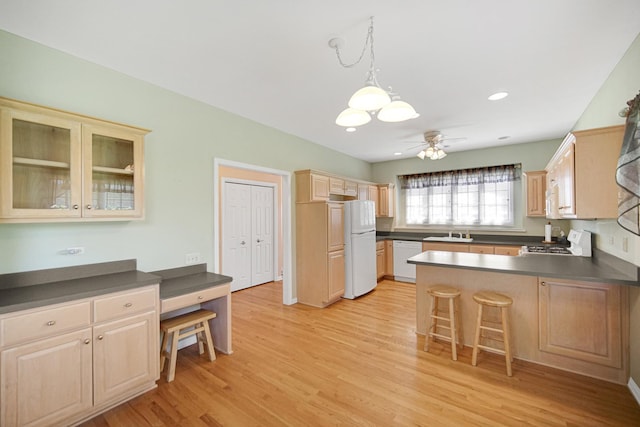 9154 Arbour Walk Dr, Frankfort, IL 60423 - kitchen featuring a sink, white appliances, dark countertops, a peninsula, and ceiling fan