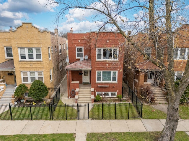 5048 W Wrightwood Ave, Chicago, IL 60639 - multi unit property with brick siding, stairs, and a fenced front yard