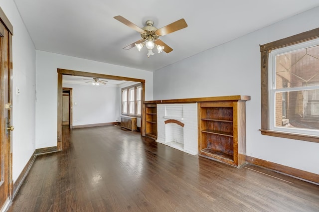 5048 W Wrightwood Ave, Chicago, IL 60639 - unfurnished living room featuring wood finished floors, a ceiling fan, and a fireplace