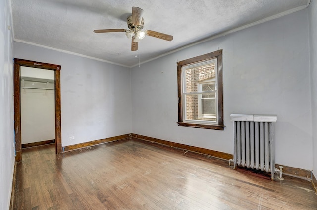 5048 W Wrightwood Ave, Chicago, IL 60639 - empty room featuring radiator heating unit, crown molding, wood finished floors, a ceiling fan, and a textured ceiling