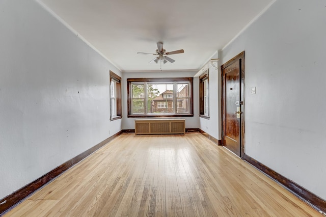 5048 W Wrightwood Ave, Chicago, IL 60639 - unfurnished living room with radiator, ceiling fan, light wood-type flooring, and ornamental molding