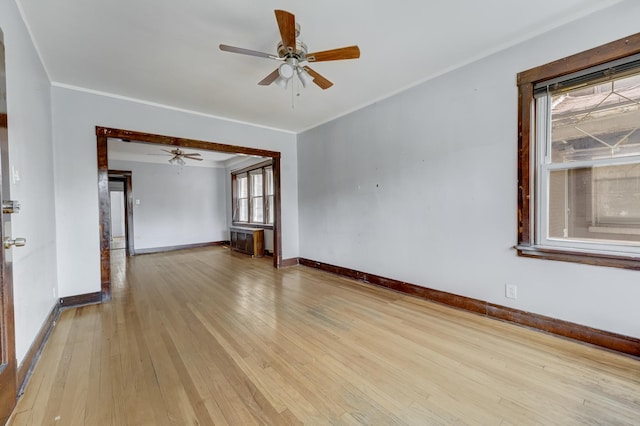 5048 W Wrightwood Ave, Chicago, IL 60639 - spare room with light wood finished floors, a ceiling fan, and crown molding