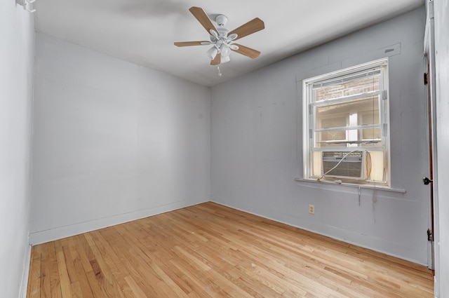5048 W Wrightwood Ave, Chicago, IL 60639 - spare room featuring cooling unit, wood finished floors, and a ceiling fan