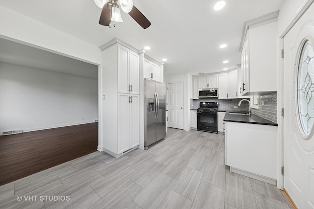 8800 44th Pl, Brookfield, IL 60513 - kitchen with appliances with stainless steel finishes, ceiling fan, recessed lighting, dark countertops, and backsplash