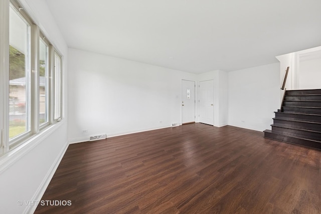 8800 44th Pl, Brookfield, IL 60513 - unfurnished living room featuring plenty of natural light, dark wood finished floors, and stairs